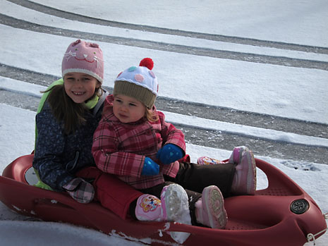 snow-girls-on-sled-2.jpg